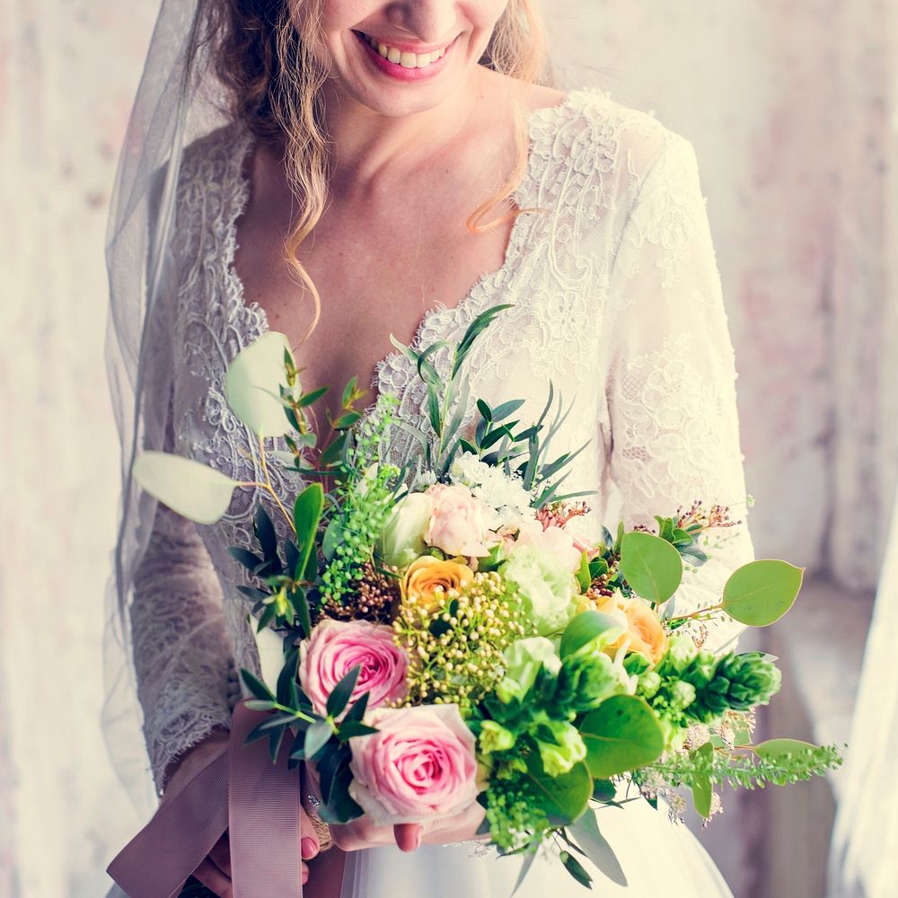 Bride in her wedding dress holding a bouquet of flowers