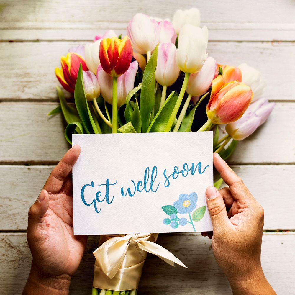 Hand Holding Show Get Well Soon Card with Tuips Flowers Background