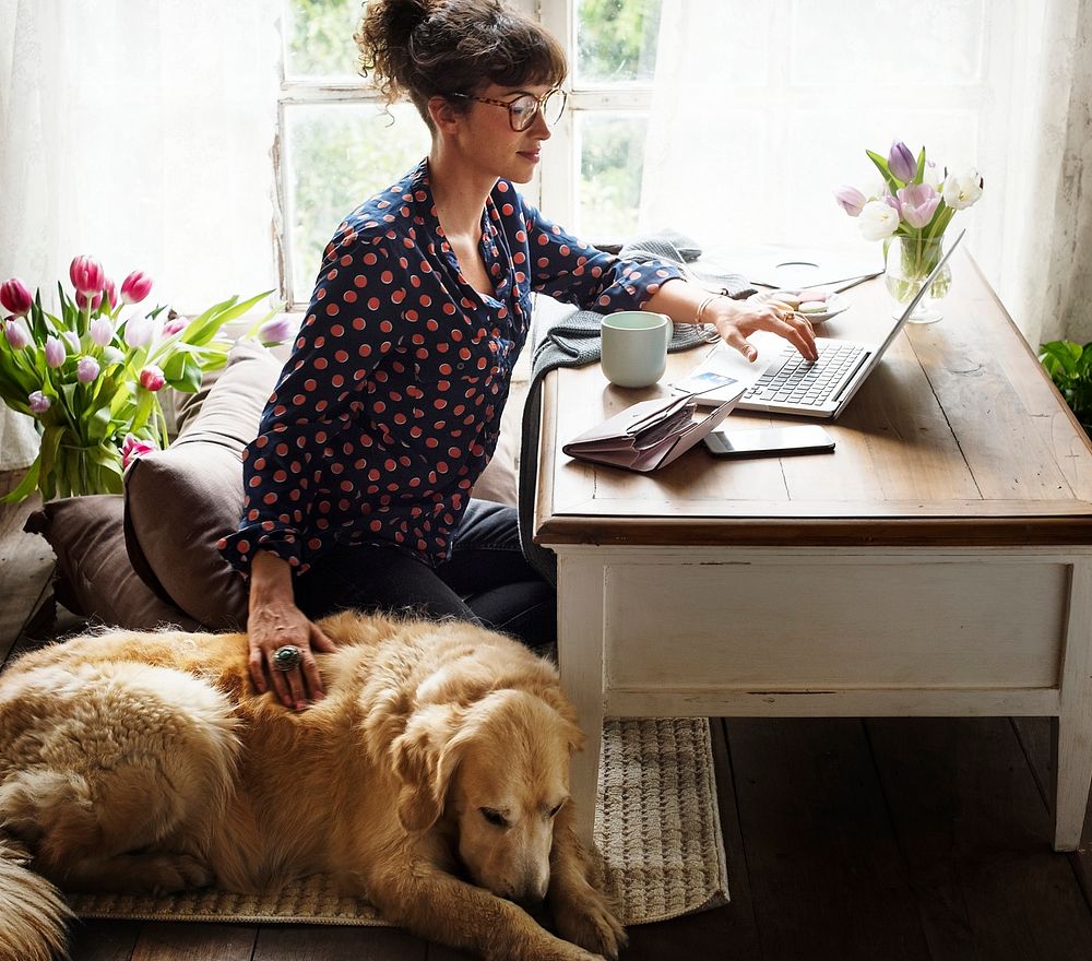 Woman working at home with her dog