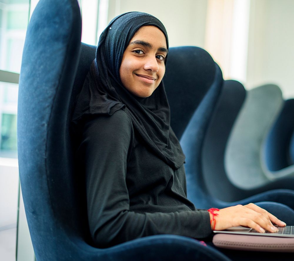 Young muslim woman using computer laptop