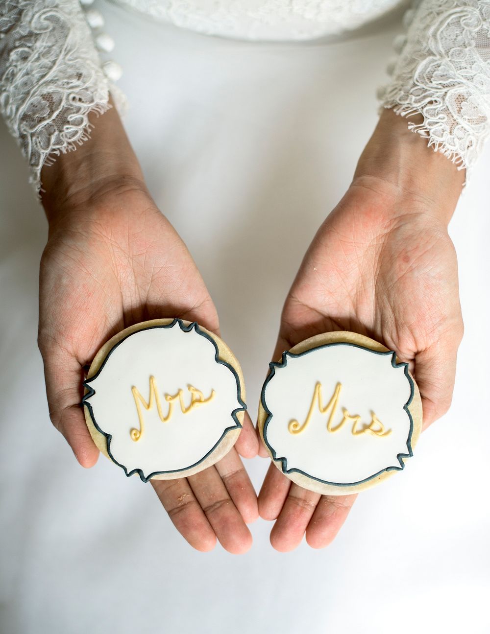Woman hands holding showing wedding cookies
