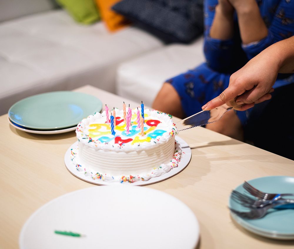 Hand cutting birthday cake