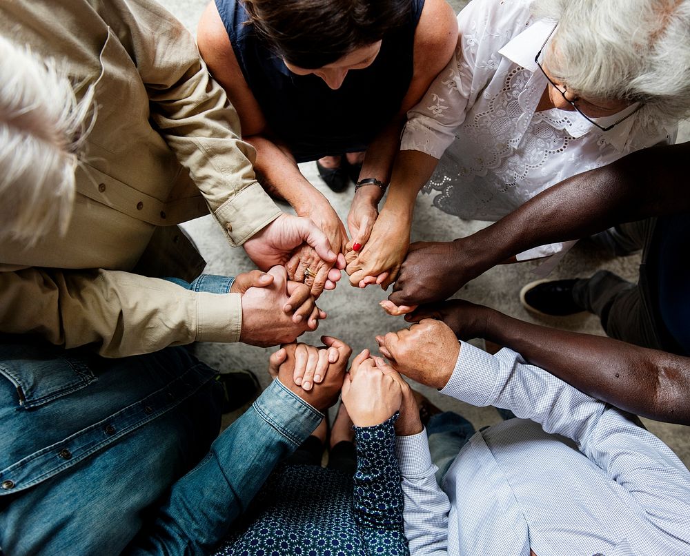 Group of diverse hands holding each other 