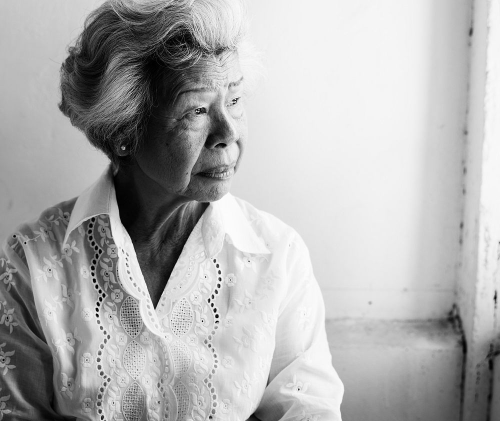 Side view of elderly asian woman with a thoughtful face expression