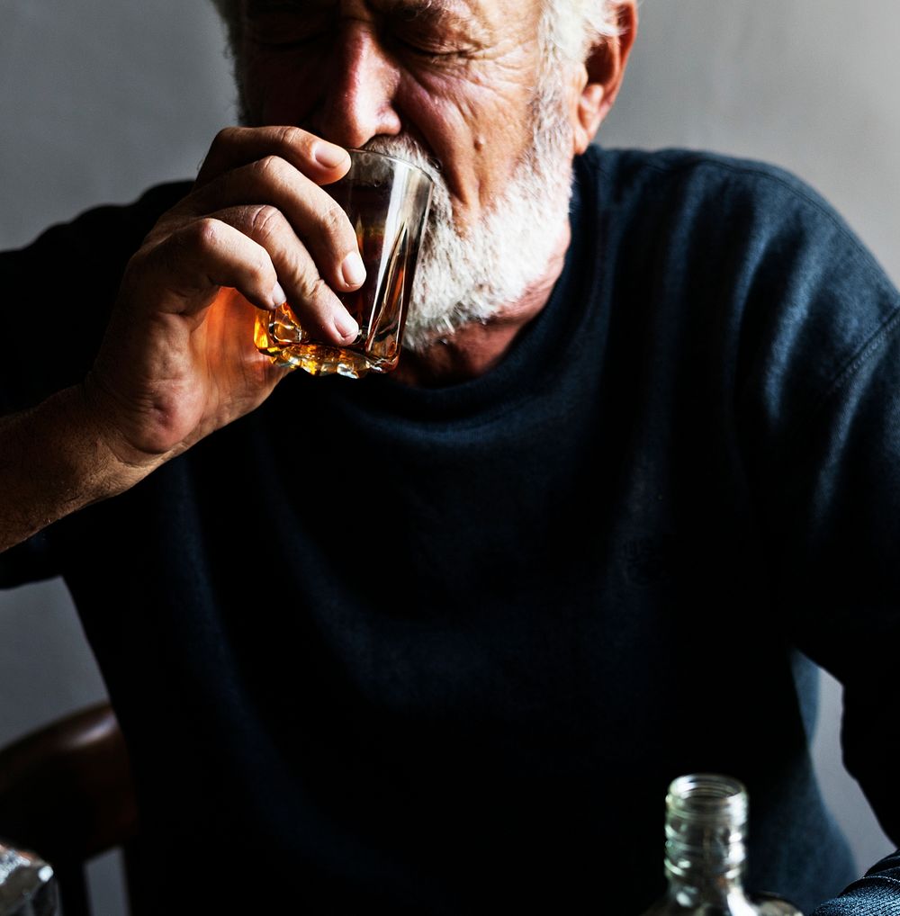 Elderly man drinking alcohol 