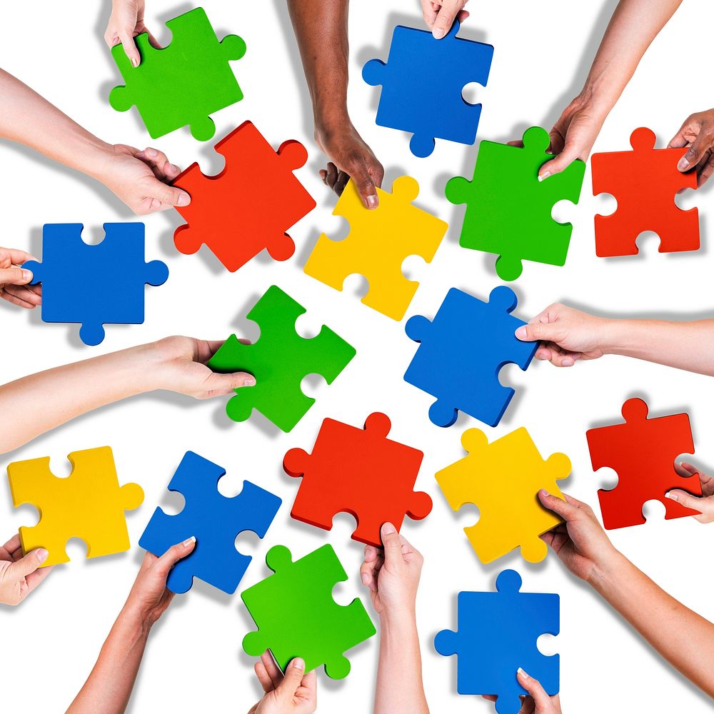 Group of Diverse Hands Holding Jigsaw Puzzle