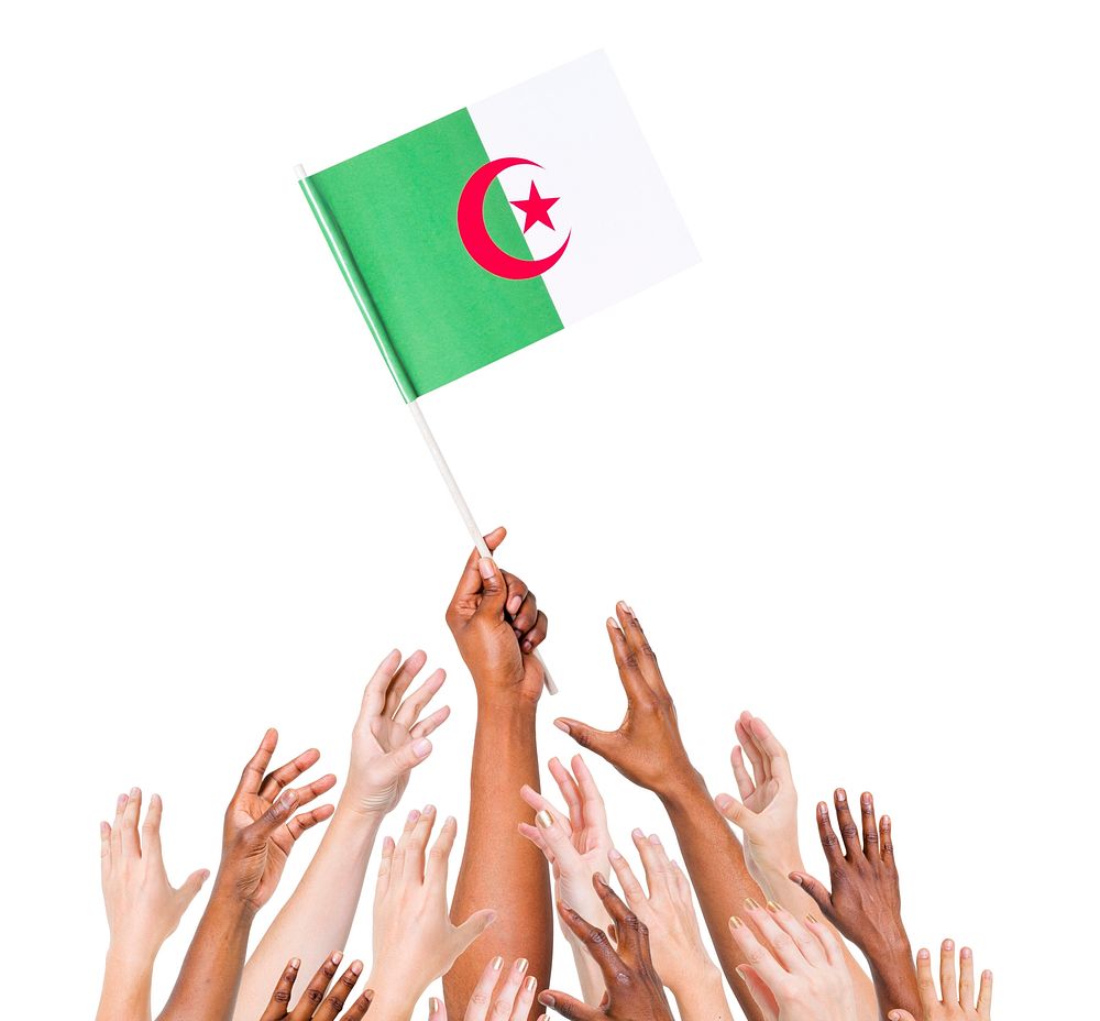 Group of people reaching for and holding the Algerian flag.