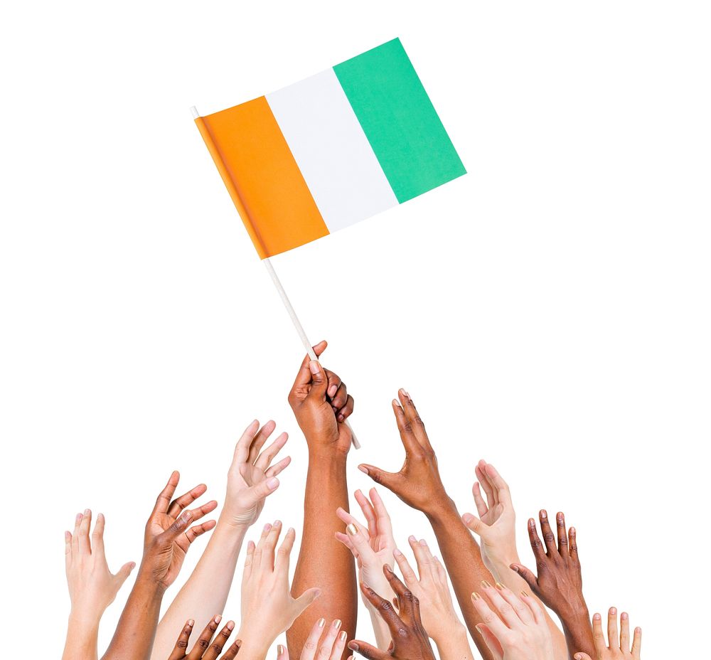 Group Of Multi-Ethnic People Reaching For And Holding The Flag Of Cote D'Ivoire