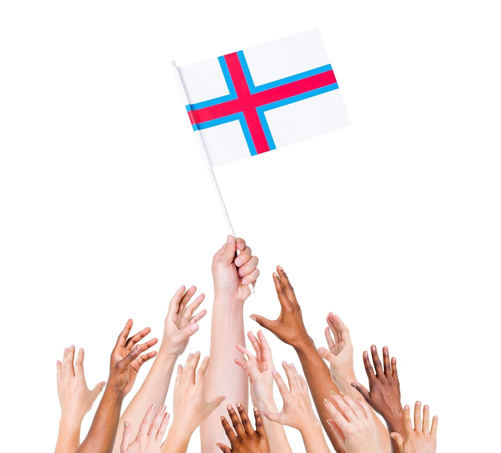 Group of multi-ethnic people reaching for and holding the flag of Faroe Islands.