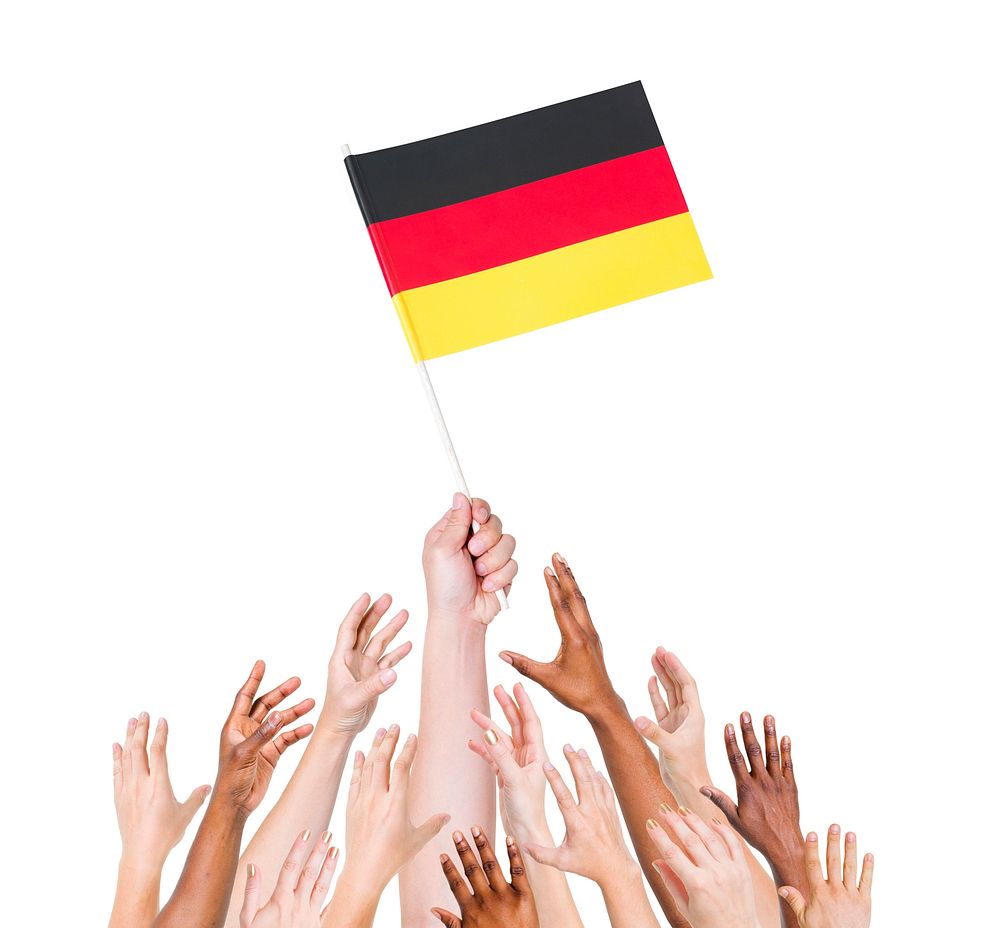 Human hand holding Germany flag among multi-ethnic group of people's hand