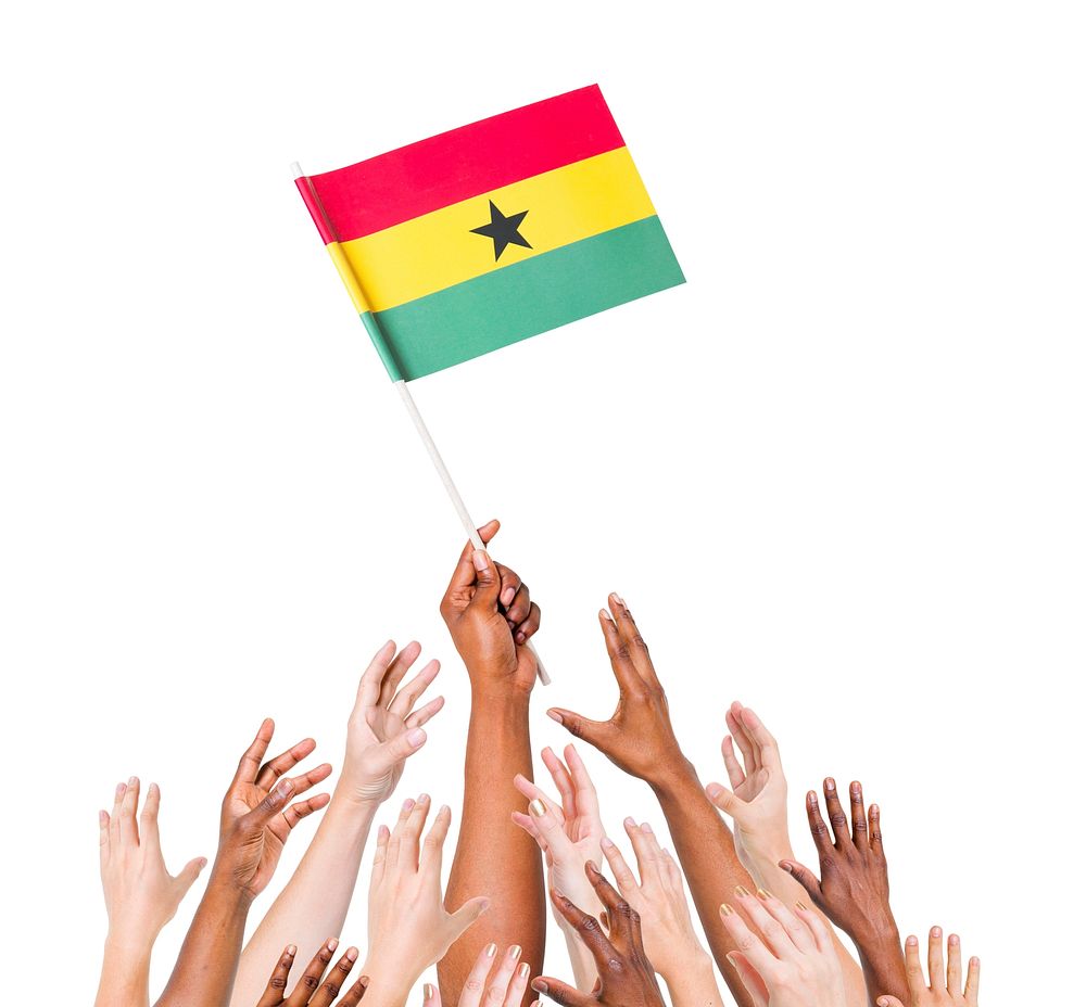 Group of multi-ethnic people reaching for and holding the flag of Ghana.