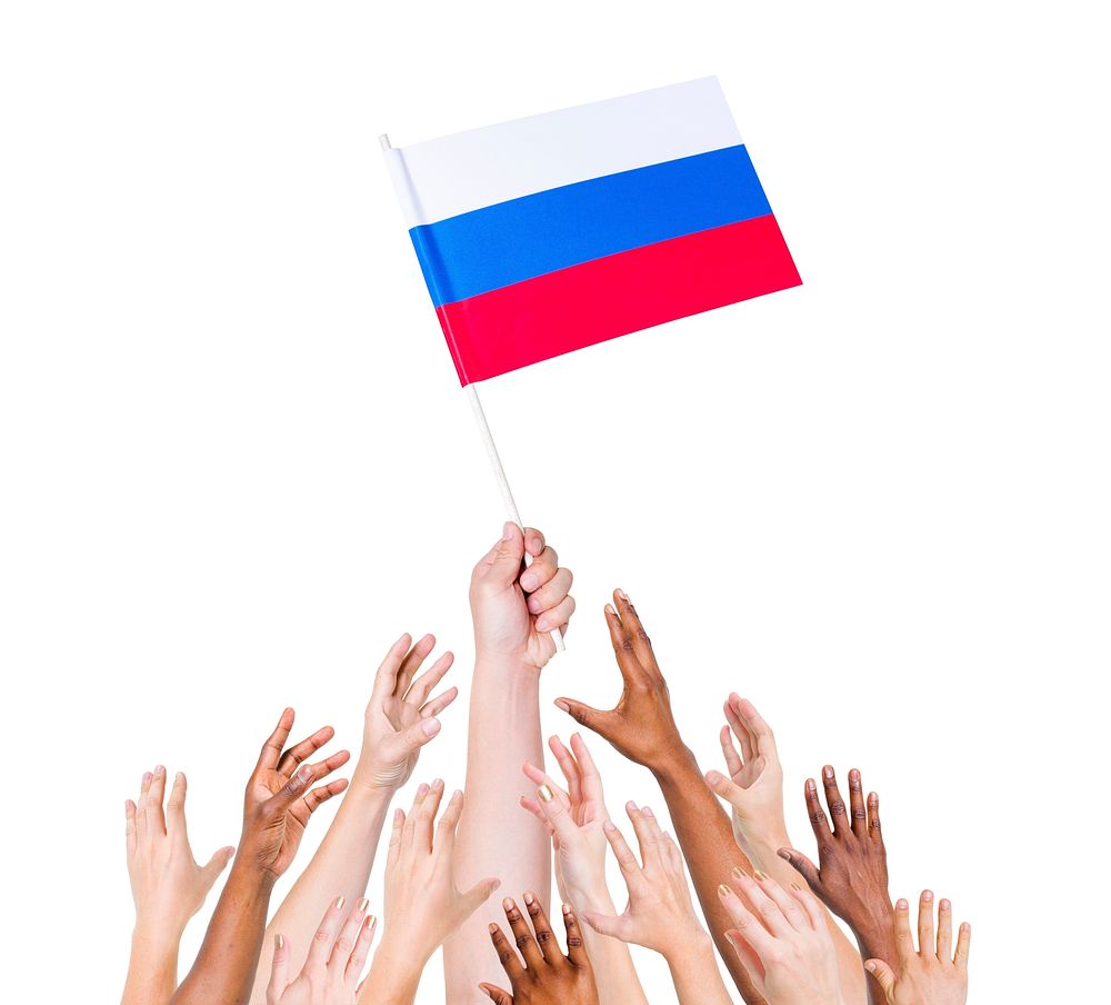 Human hand holding Russia Flag among group of multi-ethnic hands
