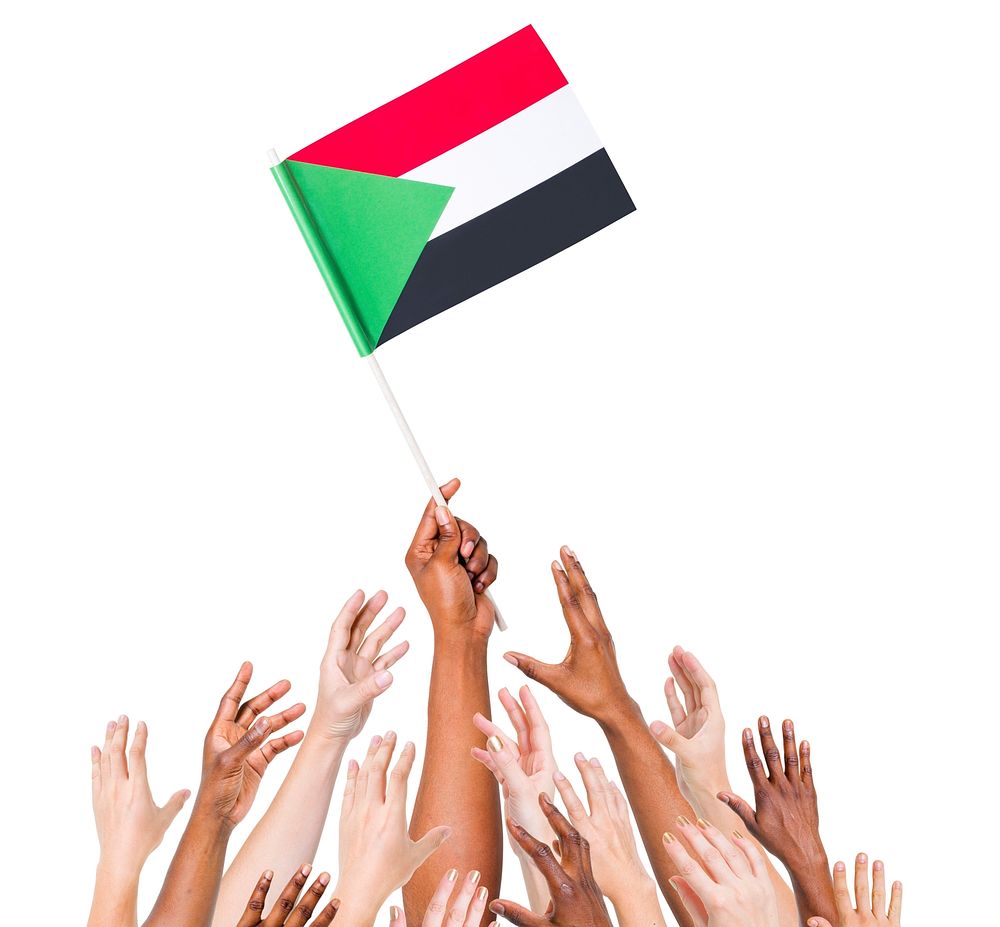 Group Of Multi-Ethnic People Reaching For And Holding The Flag Of Sudan