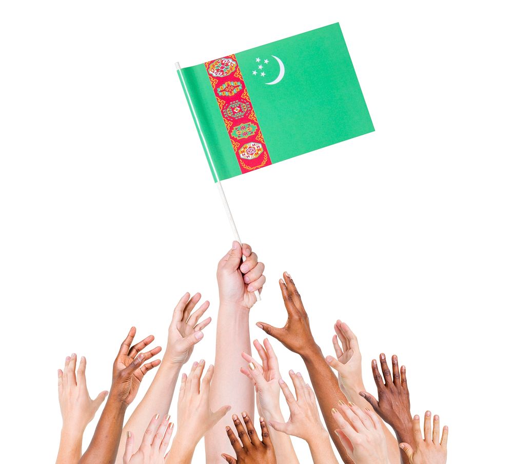Human hand holding Turkmenistan Flag among multi-ethnic group of people's hand