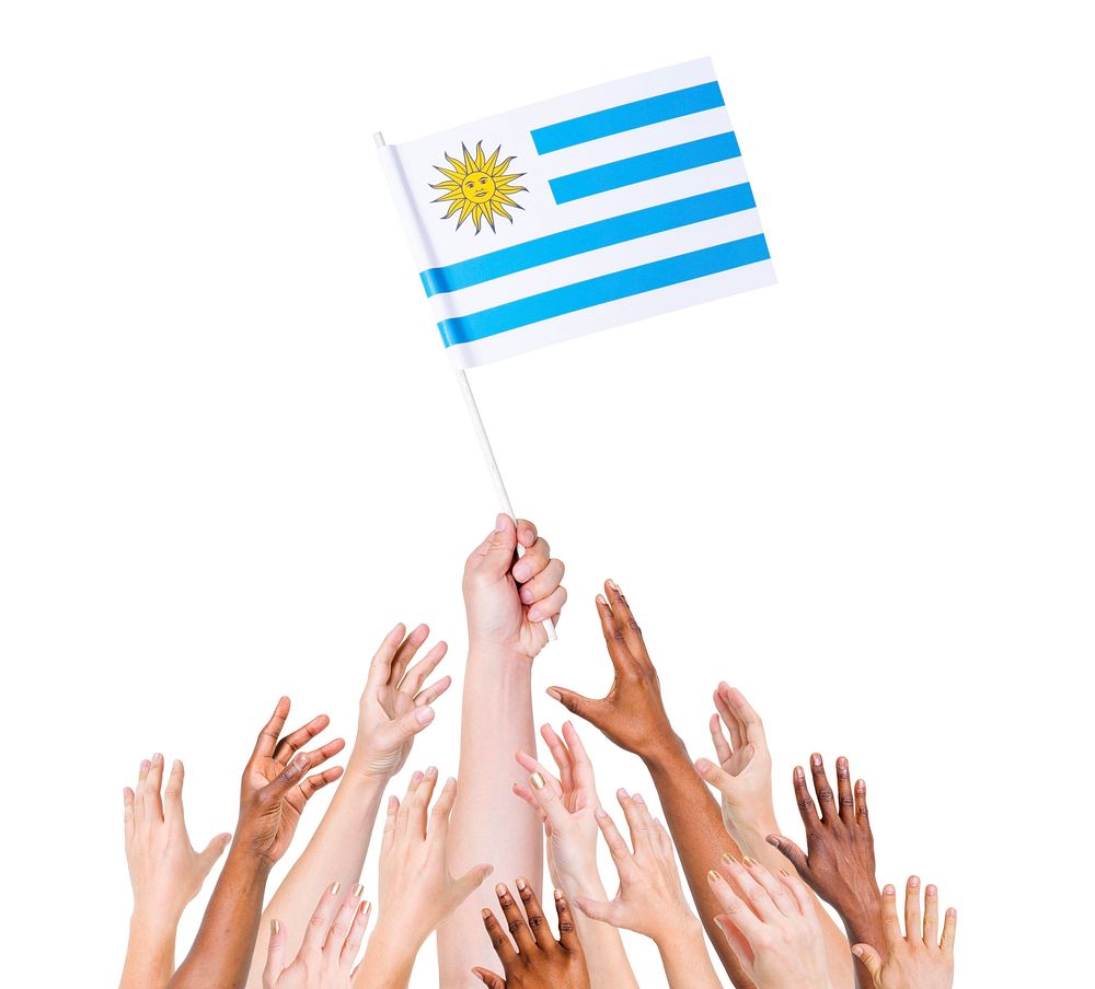 Human hand holding Uruguay flag among multi-ethnic group of people's hand