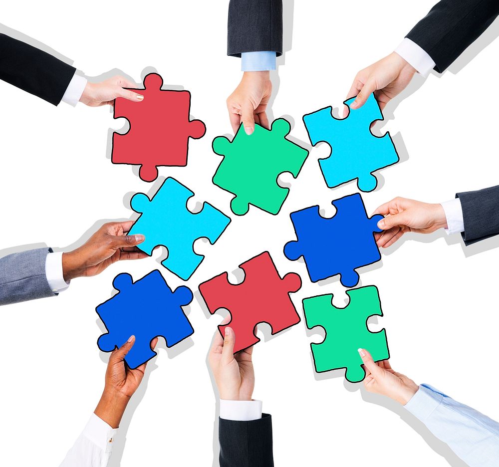 Group of Hands with Jigsaw Puzzle