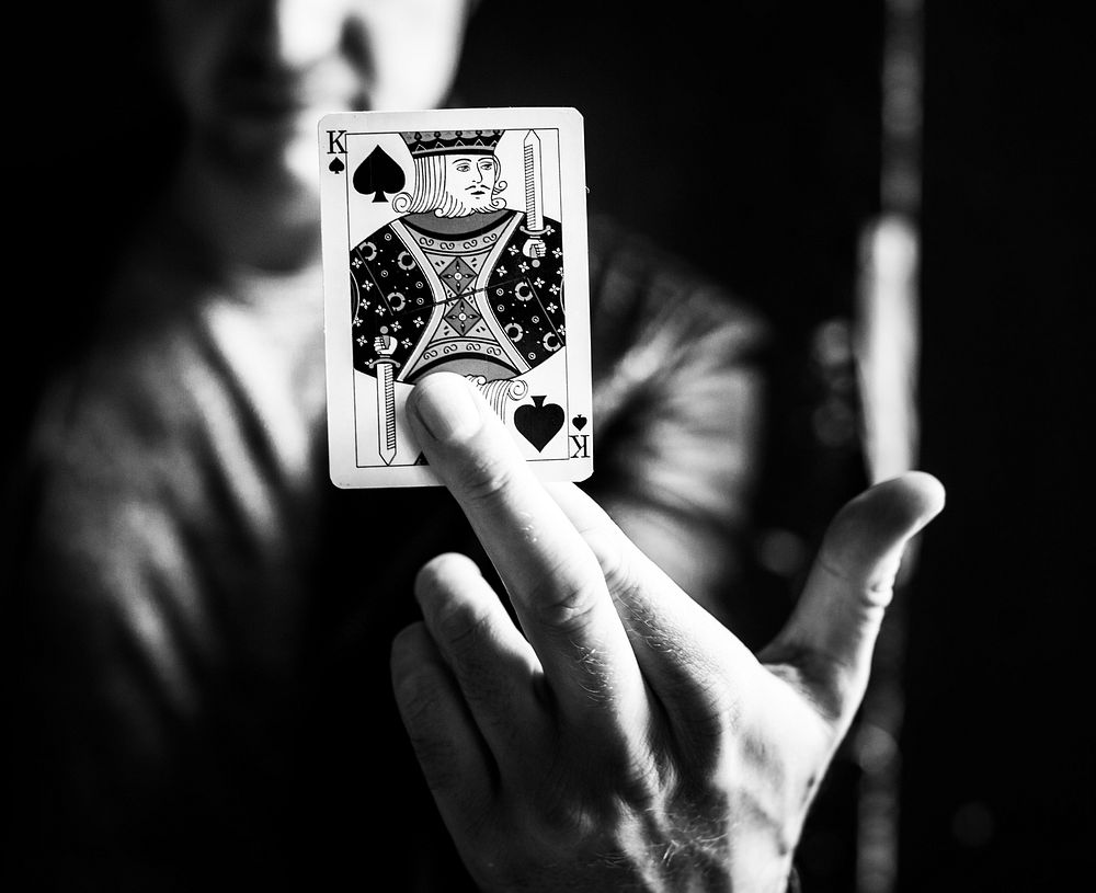 Closeup of a hand holding a playing card