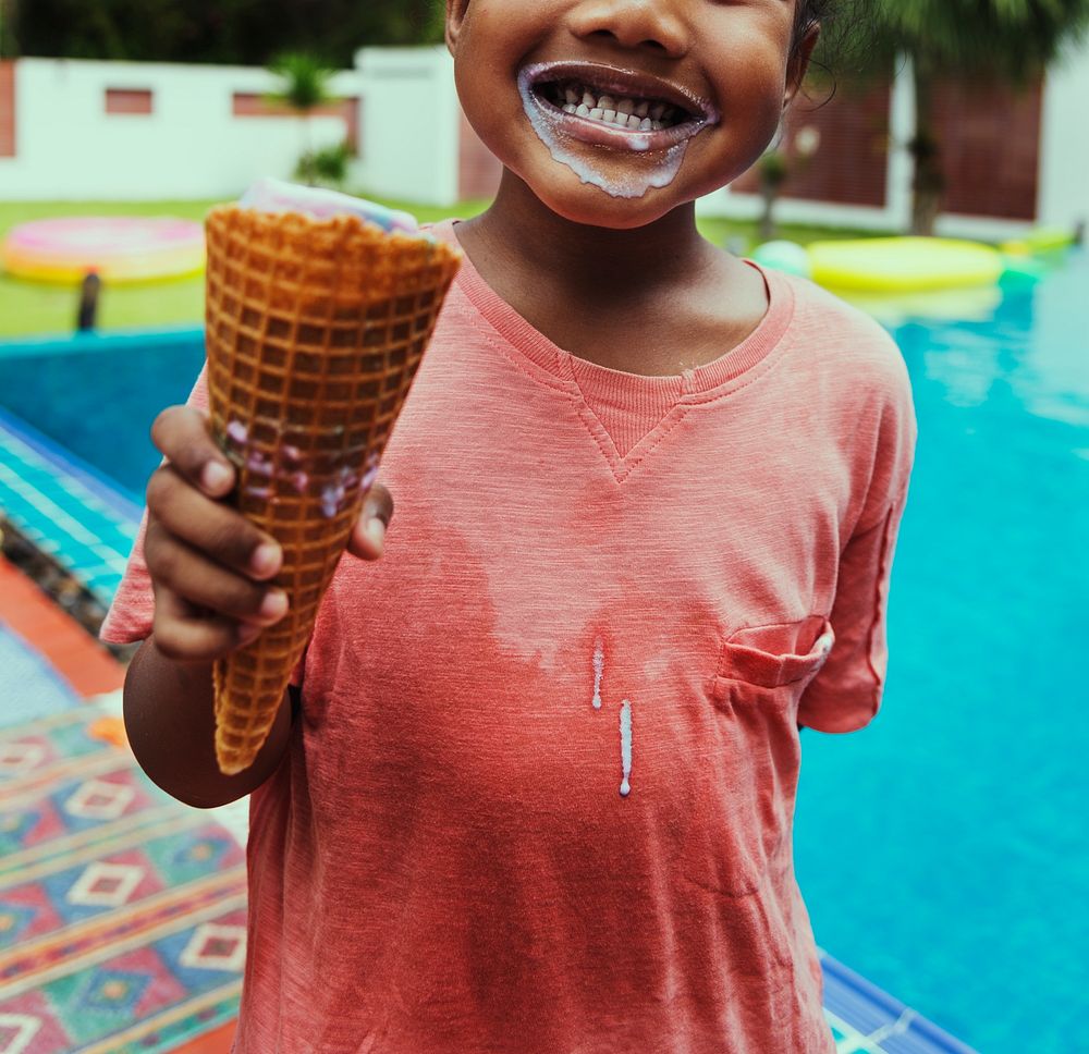 Closeup of african descent girl with ice cream by the pool