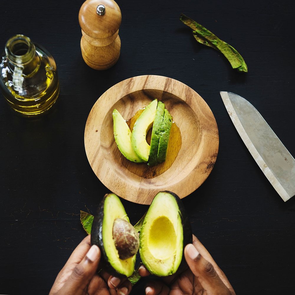 Closeup of fresh avocado on wooden plate