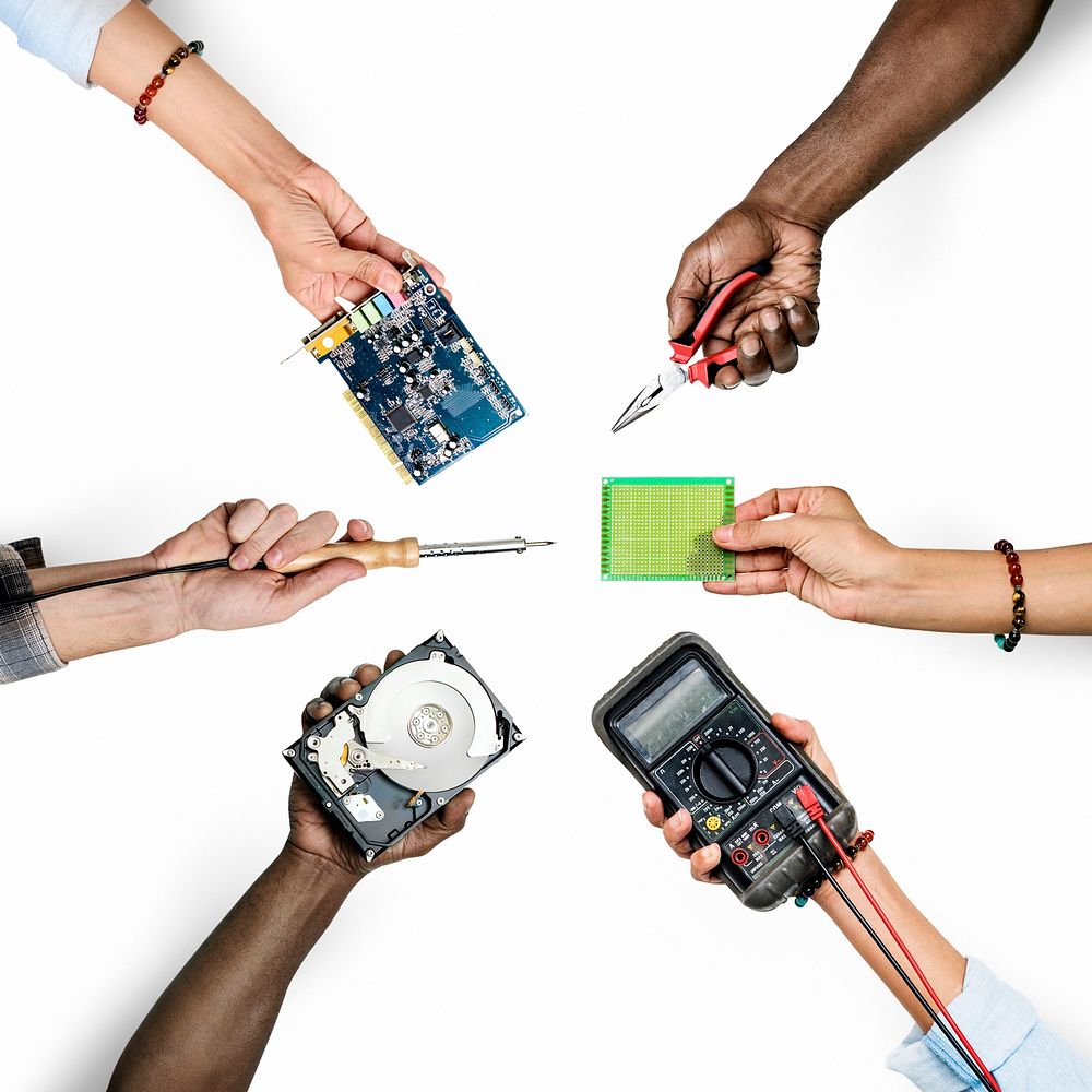 Group of hands holding computer electronics parts isolated on white