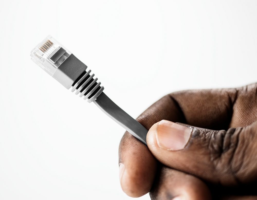 Hand holding LAN cable isolated on background