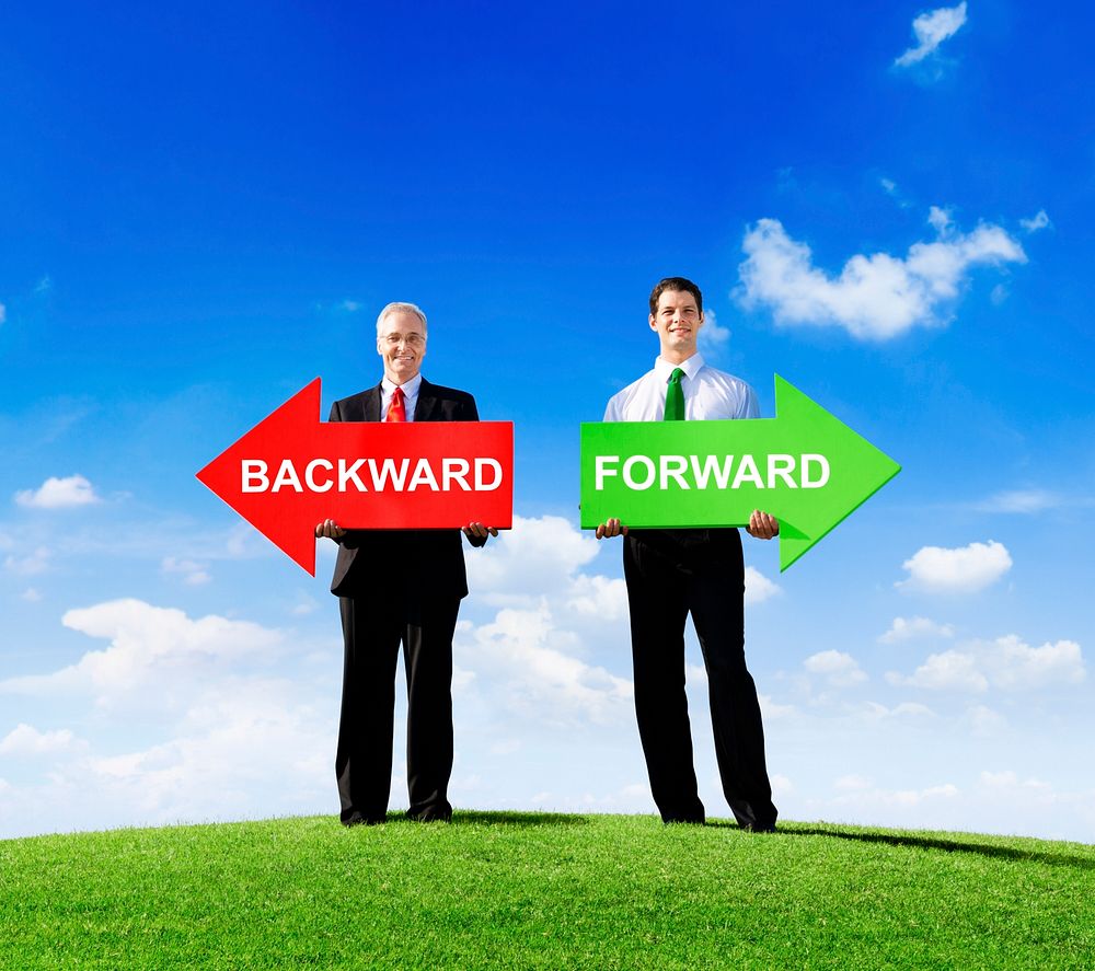Two Businessmen Holding Contrasting Arrows for Backward and Forward