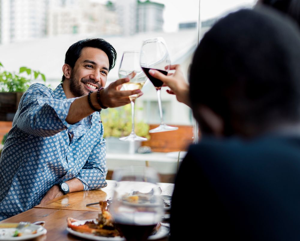 People cheers a wine glasses together