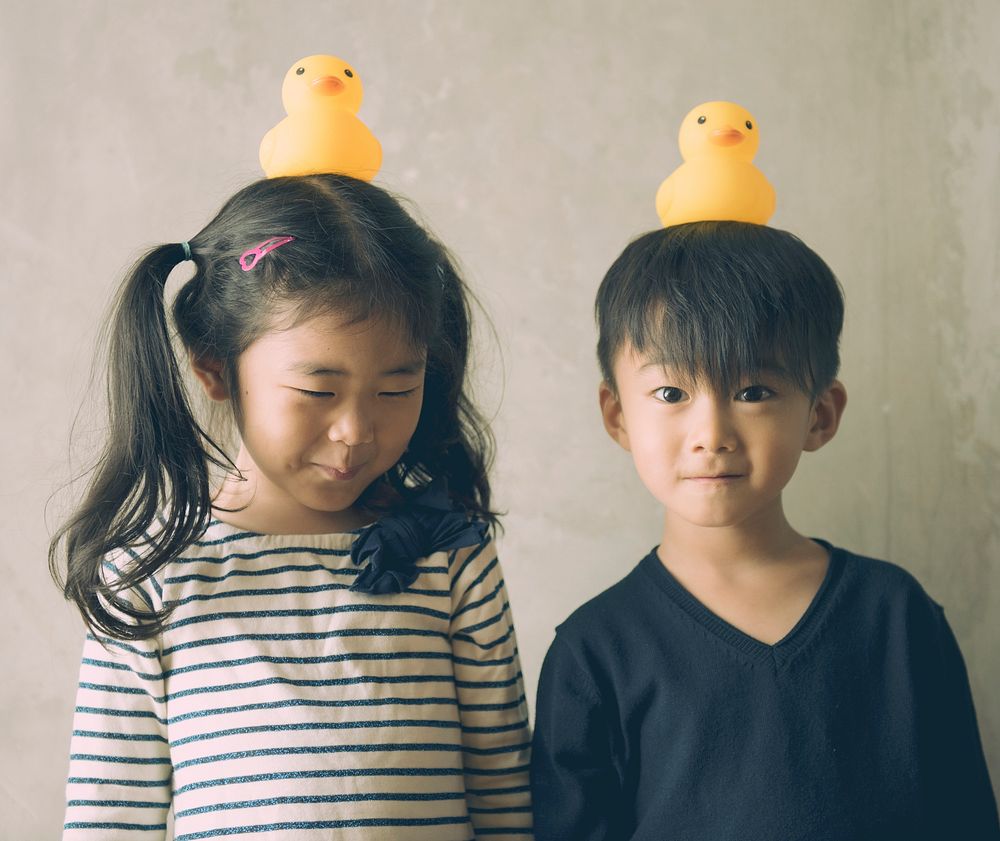 Japanese kids with rubber duckies on their heads