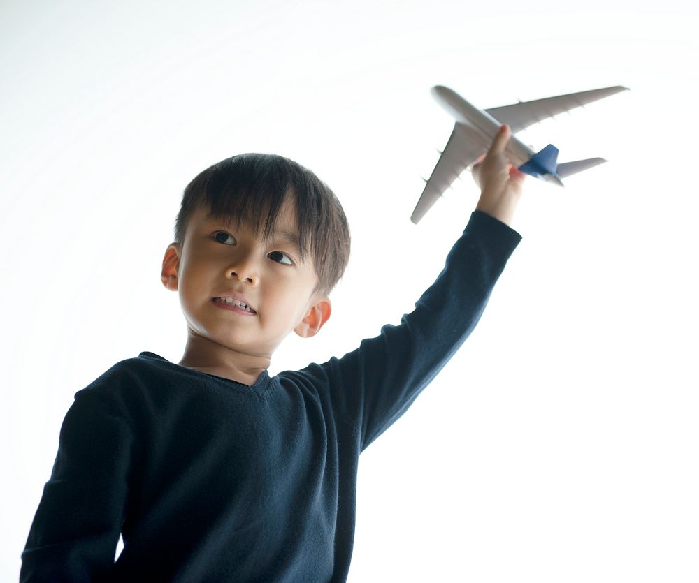 Japanese boy playing with his toy plane