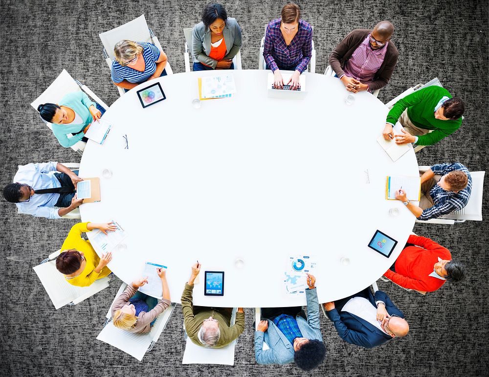 Aerial view of people seated around a meeting table