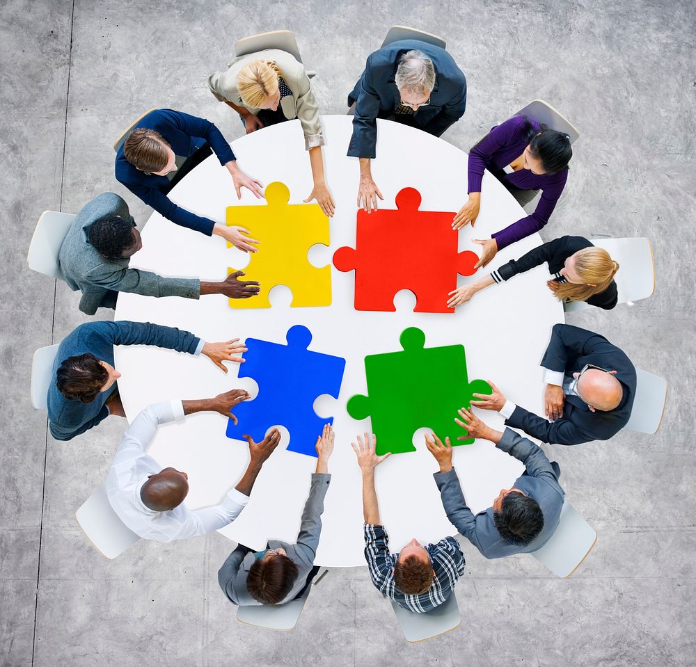 Business People with Jigsaw Pieces for Connection Concept