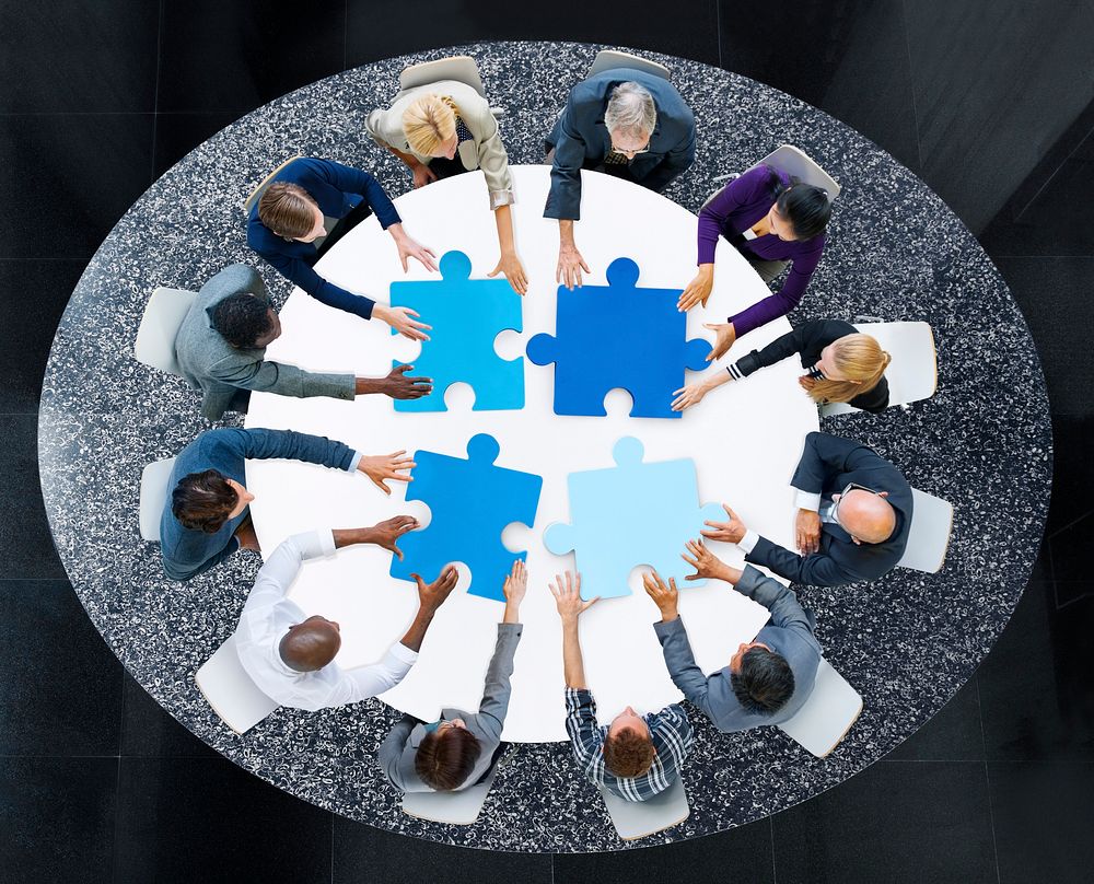 Business People with Puzzle Pieces and Teamwork Concept
