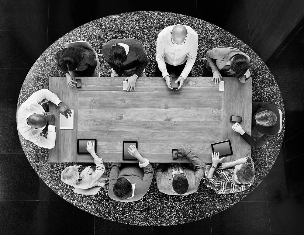 Group of Diverse People in a Table Using Devices