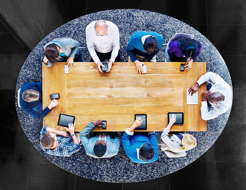 Group of Diverse People in a Table Using Devices Concept