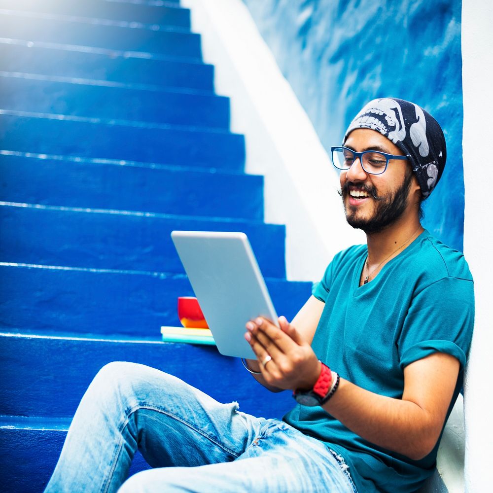 Sikh Guy Browsing Tablet Stair Case Concept