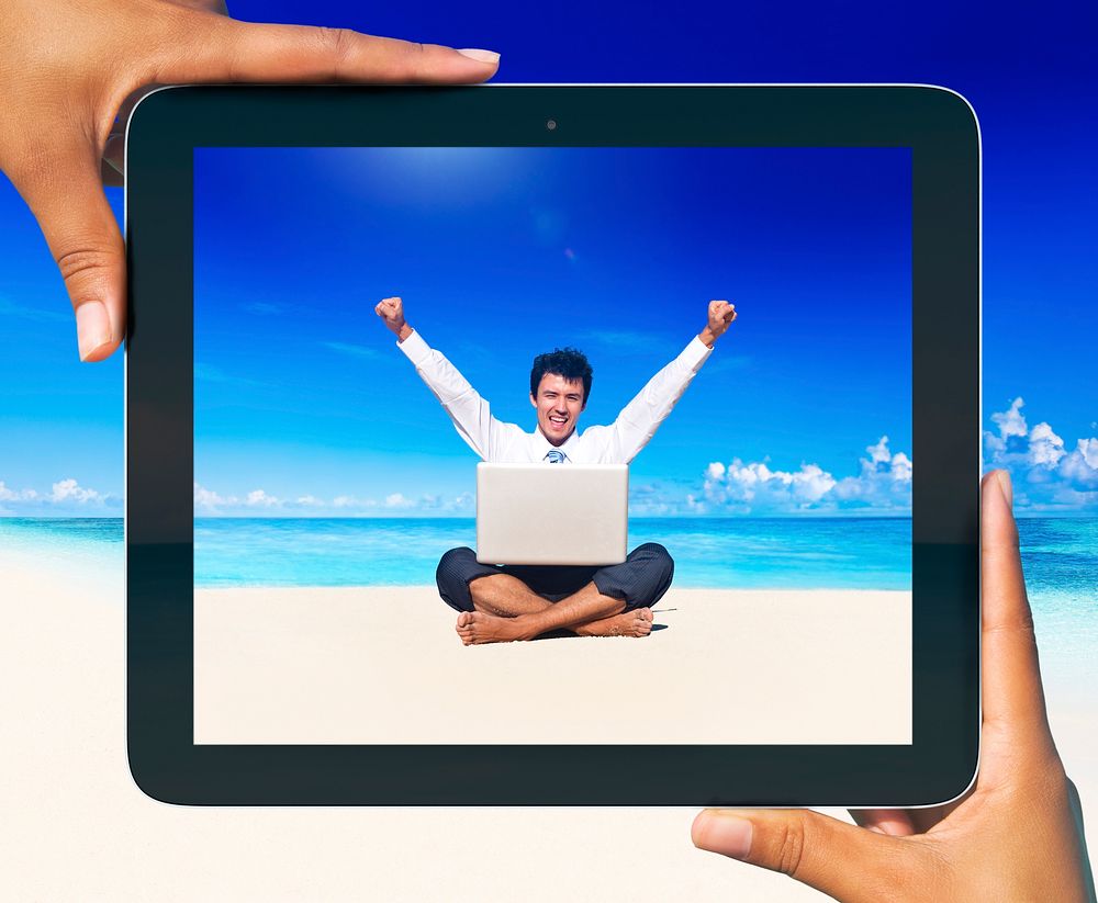 Digital Tablet with photo of a man on the beach.
