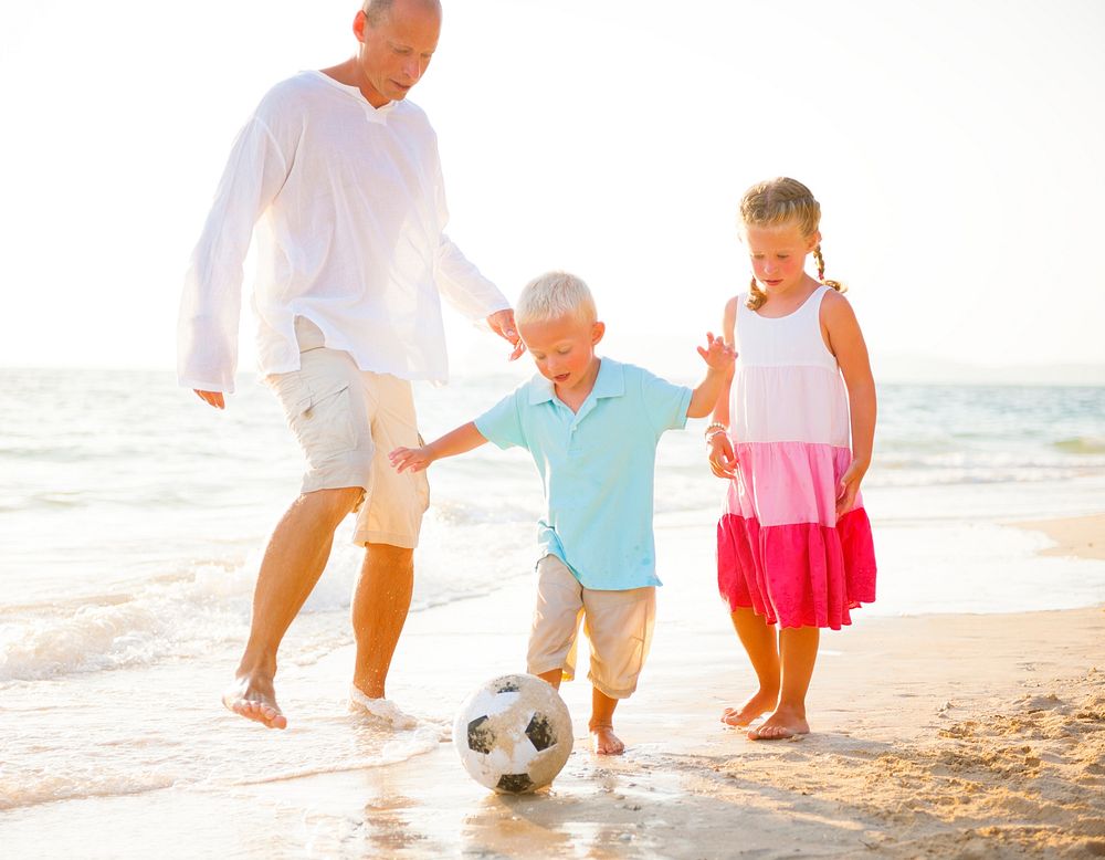 Family playing on the beach.