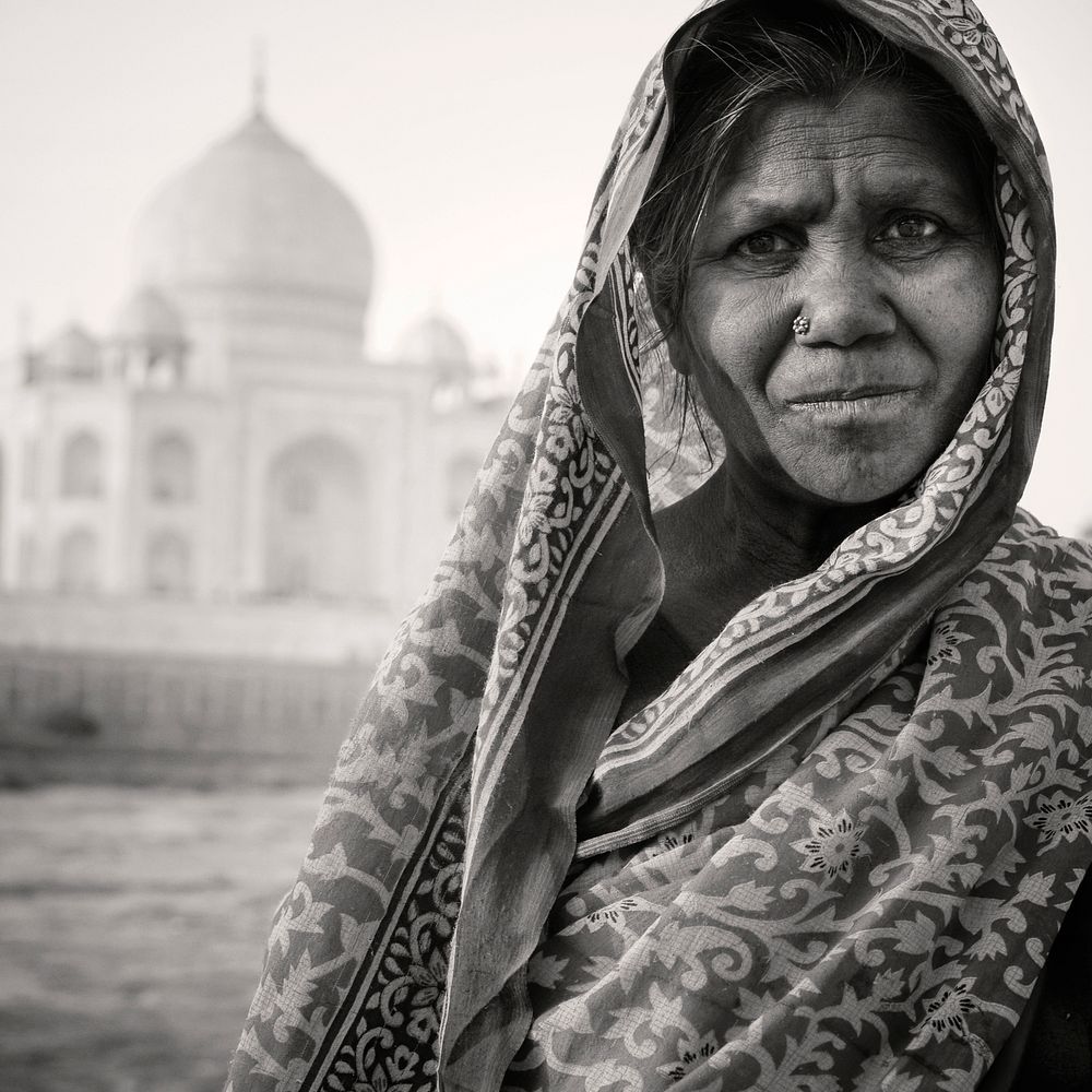 Indigenous Indian woman and The Taj Mahal as a background.