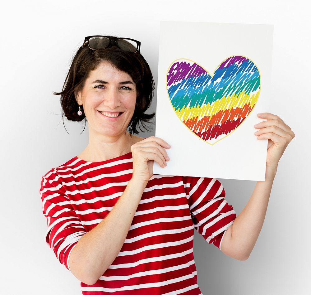 Woman holding placard with LGBT heart icon
