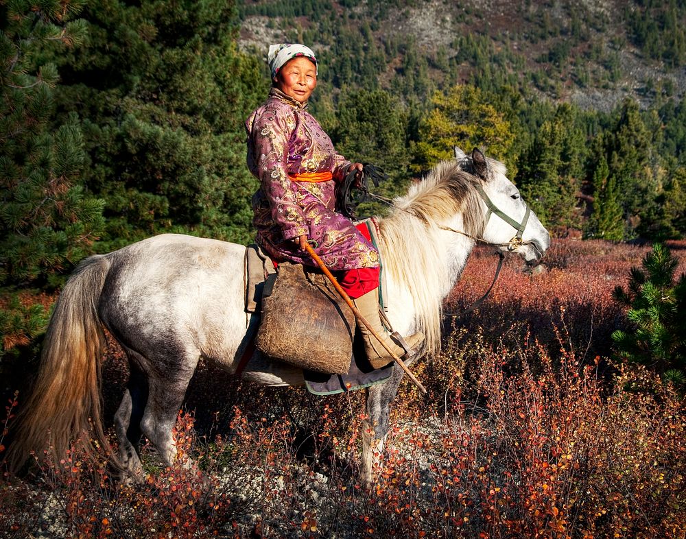 Woman riding a horse in Mongolia