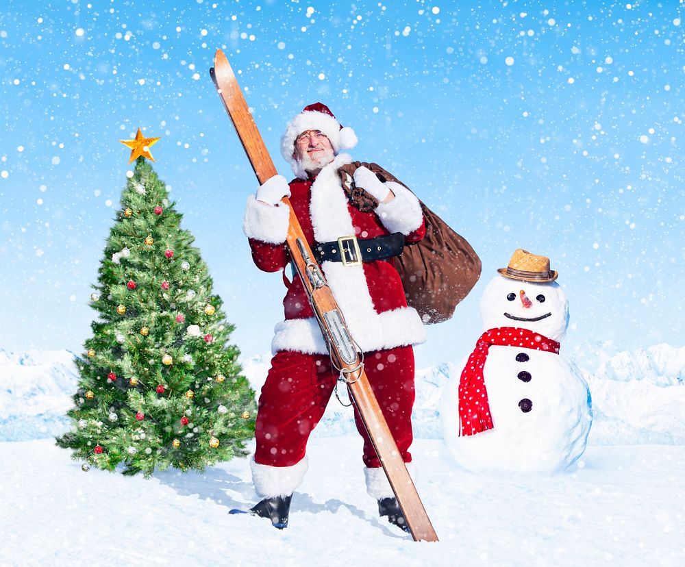 Santa claus holding sack and skis next to a christmas tree.