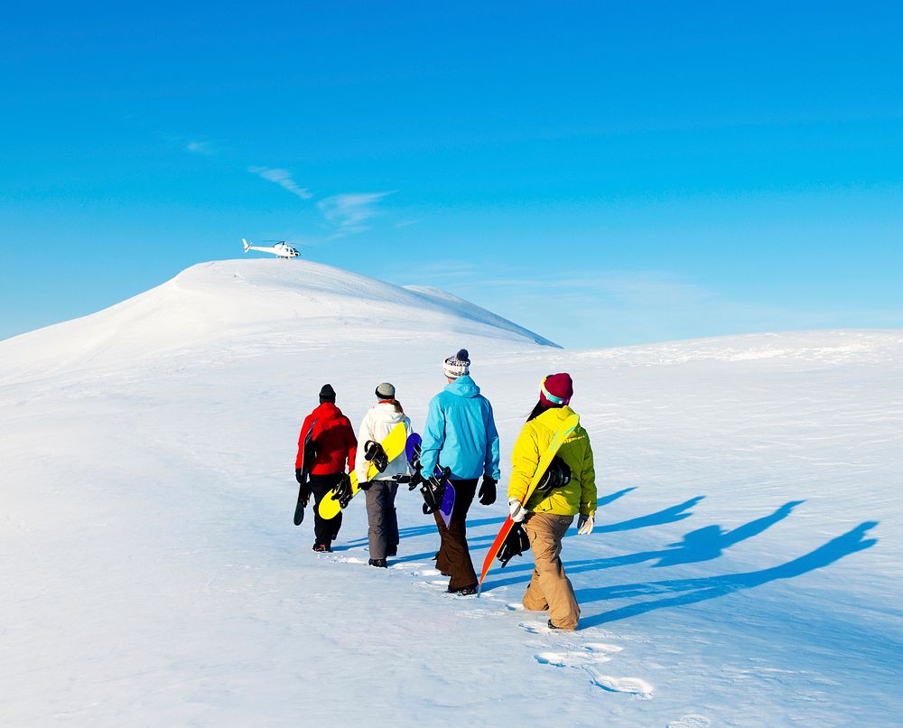Group of snowboarders enjoying a beautiful winter morning.