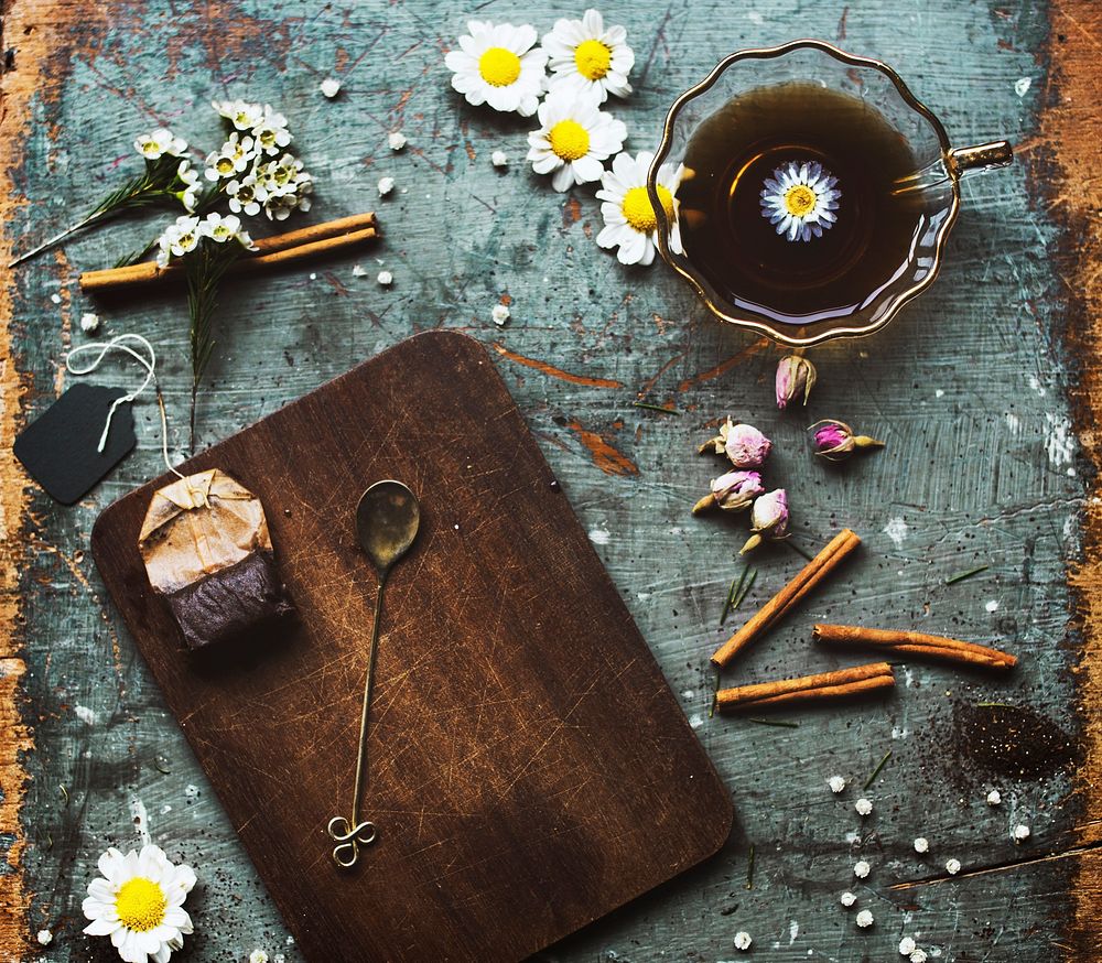 Chamomile tea with herbal on grunge background
