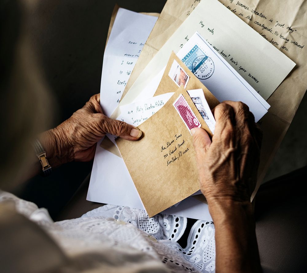 Elderly asian woman holding old letters in her hands