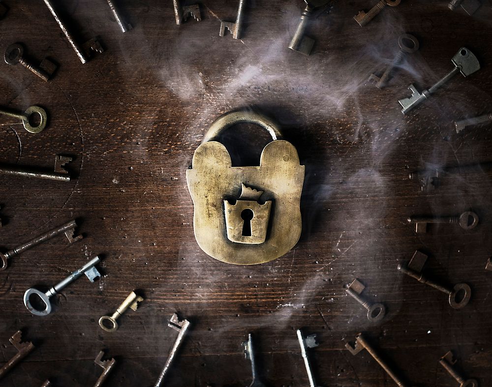 Rusty metal padlock surrounded by keys