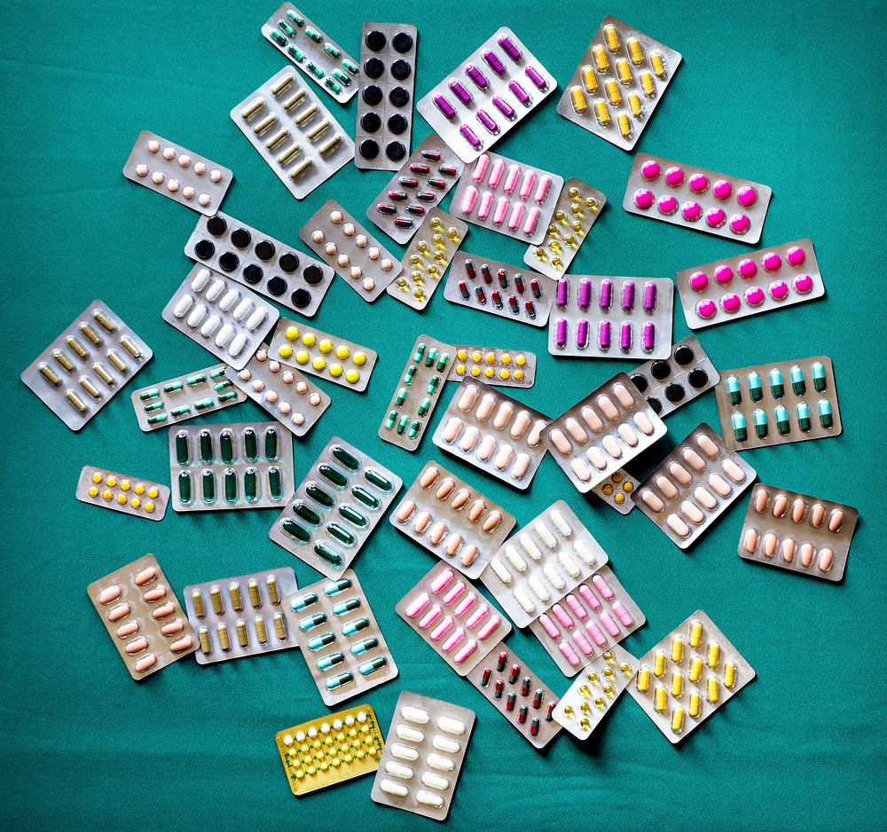 A bunch of pills tablet packets on the table