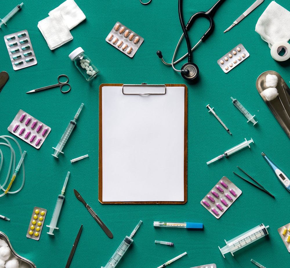 Blank clipboard with medical stuff on the table