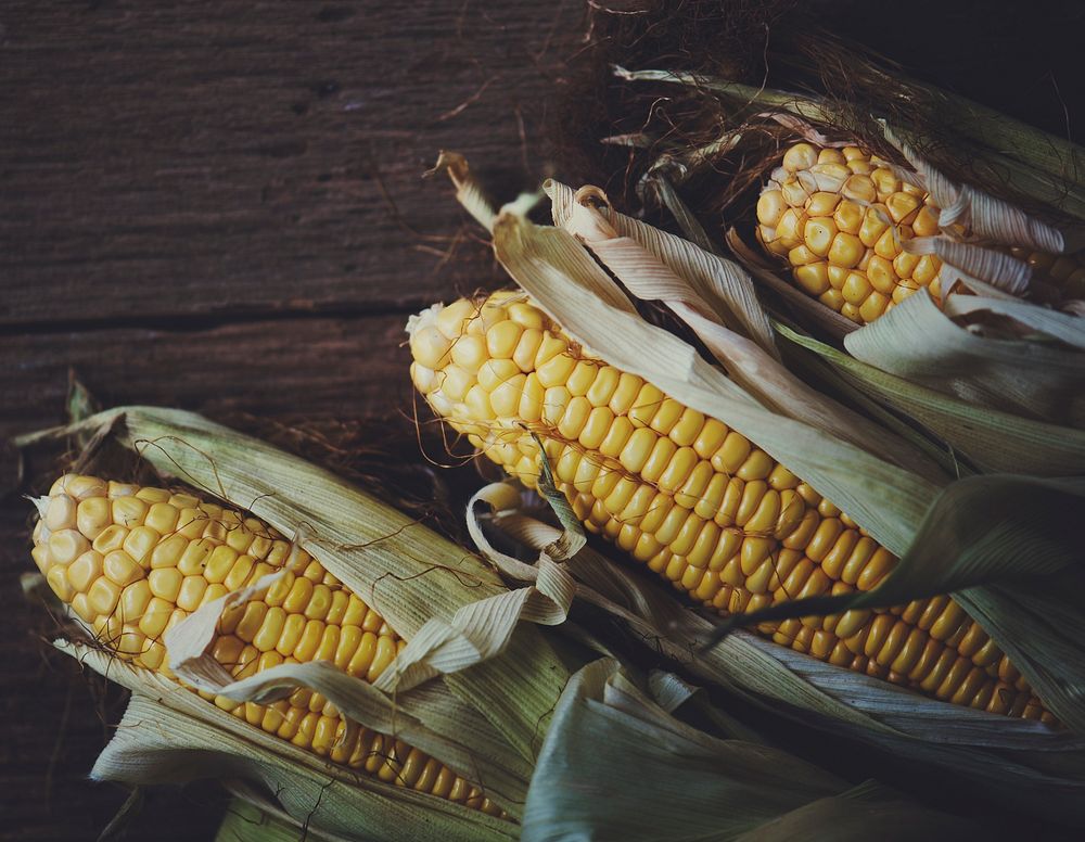 Raw yellow corn on a wooden