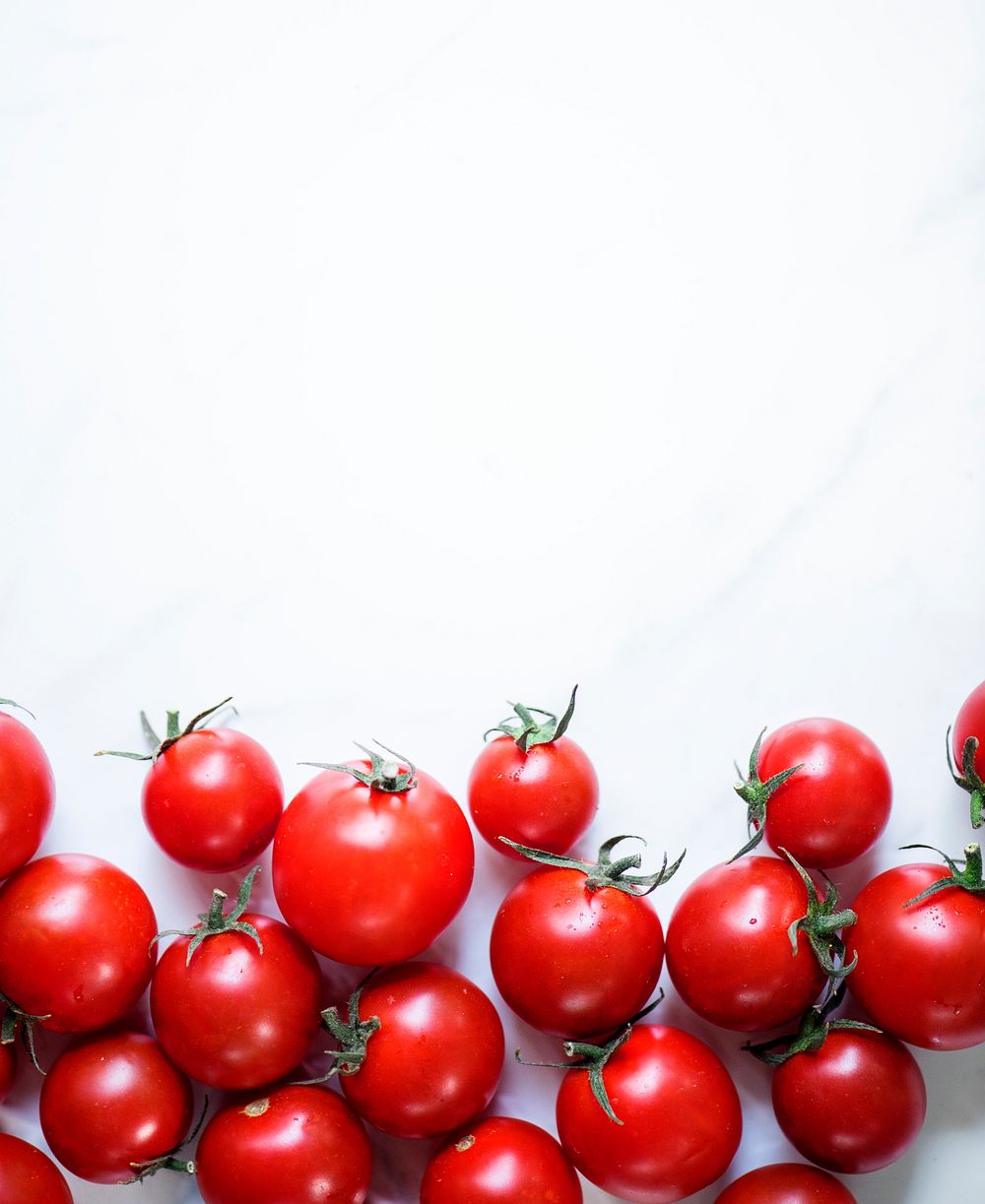 Closeup of fresh organic tomatoes on white background