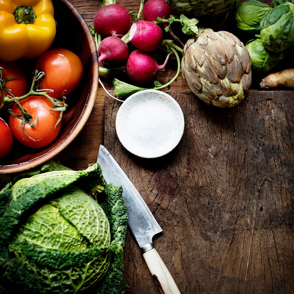 Aerial view of various fresh vegetable with knife and wooden cutboard